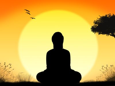 a graphic showing buddha with sunset in the background